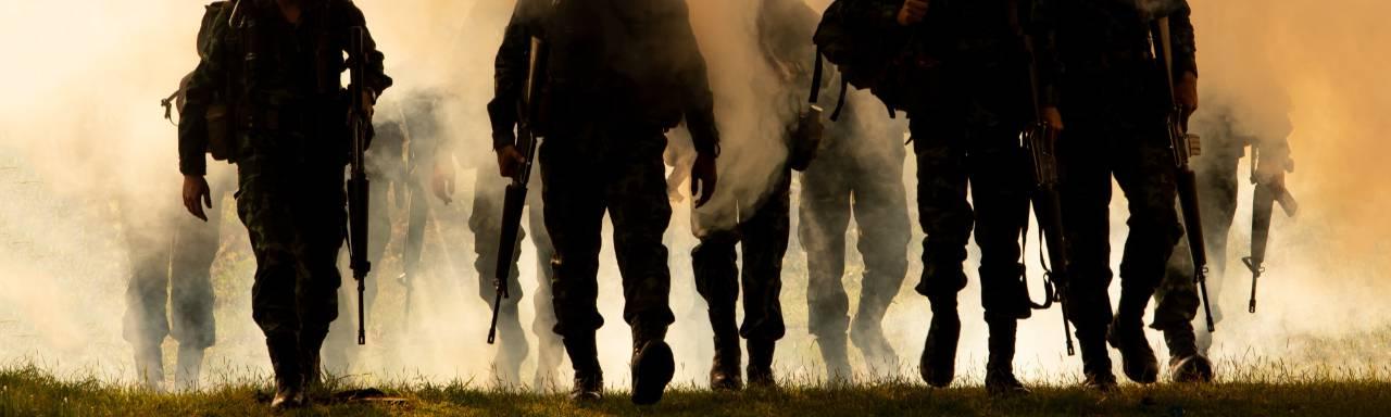 soldiers walking with orange mist